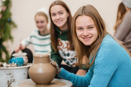 Potter shaping clay on a pottery wheel with joyful classmates in a bright studio environment