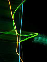 colorful light trails in dark background. Abstract light routes that rotate in vibrant colors. Forestry of the blurry movement of light painting. Blurred lights at night. Intentional camera movement, 