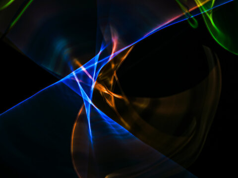 colorful light trails in dark background. Abstract light routes that rotate in vibrant colors. Forestry of the blurry movement of light painting. Blurred lights at night. Intentional camera movement, 