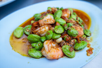 Delicious shrimp and petai dish local market food vibrant setting close-up culinary experience