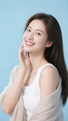 Fototapeta premium A woman with a gentle smile, wearing a white top and light shawl, against a soft blue background.