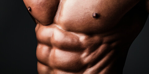 Naklejka premium Muscular male body. Sexy male naked torso. Strong man with muscular body. Sexy male bare torso. Shirtless athletic hot guy with muscular abs. Mans powerful. Muscular man showing six pack abs.