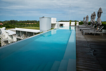 Relaxing infinity pool overlooking scenic landscape luxury resort modern architecture tranquil environment