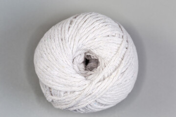Coil of white cooking twine on gray background, top view