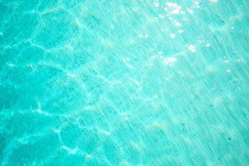 Obraz premium Aqua Blue Water Texture with Light Reflections Shimmering Surface Rippled Ocean Background Teal Sea Pattern