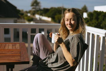 Woman Enjoying Morning Coffee on Home Terrace
