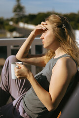 Woman Enjoying Morning Coffee on Home Terrace