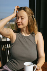 Woman Enjoying Morning Coffee on Home Terrace