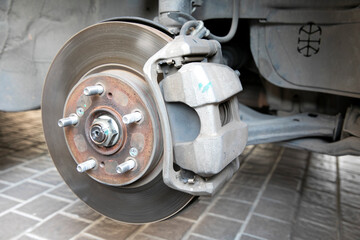 Disk brake and caliper in process of tire replacement