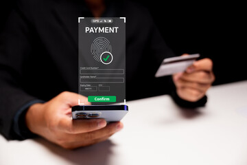 A person confirms a mobile payment using fingerprint authentication while holding a credit card and smartphone.