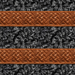 Seamless 4k photo material texture of black fur with brown viking ornament embossed leather straps.