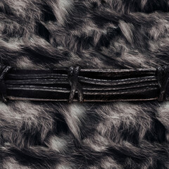 Seamless 4k photo material texture of gray fur with leather weave straps.