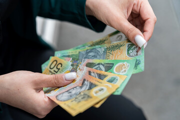 woman is holding an new 50 100 Australian currency. Concept of economy and finance