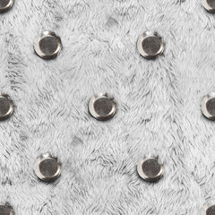 Seamless 4k photo texture of white fur material with metal studs or buttons.