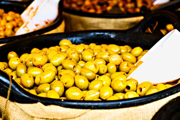 Container with fresh and delicious green olives	
