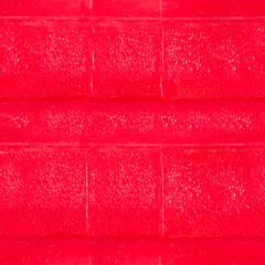 Seamless 4k photo texture material of red colored worn plastic surface.