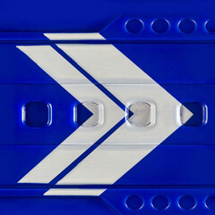 Seamless 4k photo texture material of blue plastic tech panel surface with geometric decals.