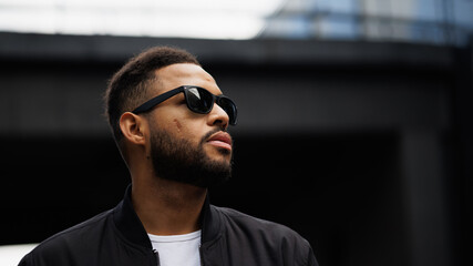 Portrait of african american man in sunglasses on urban street