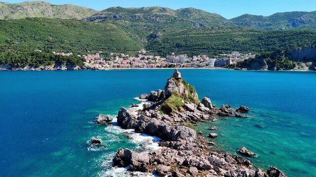 Aerial drone view of the Sveta Nedelja church in Montenegro. A Christian church on a tiny rocky island in the sea near the town of Petrovac.