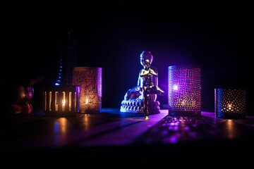 Yoga Concept with Namaste Statue and Oriental-Inspired Miniature on Table