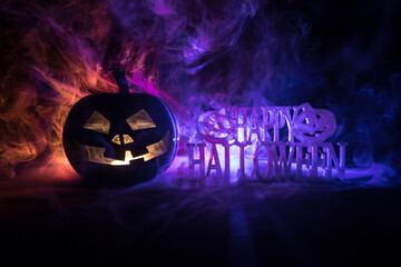 Halloween concept. Creepy silhouette in the dark corridor with pumpkin head. Toned light with fog on background.