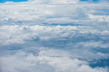 Vivid photo of clouds and sky from an airplane window.