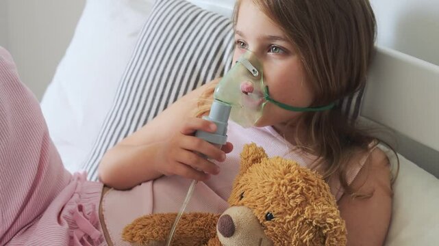 Caucasian child girl in ihalation mask using nebulizer.Health care. Virus and cough treatment.