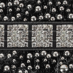 Seamless 4k photo texture material of black patterned and polished leather surface with rivets and...