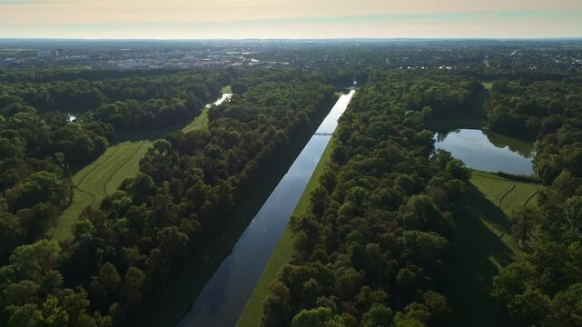 Aerial view of Schlosspark Nymphenburg and the Schlo&szlig;gartenkanal in Munich, Germany, showcasing the grand palace gardens and tree-lined canal. 