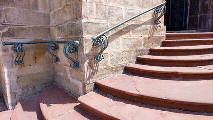 Old Stone Stairs With Decorative Railings Leading to a Historic Building Entrance