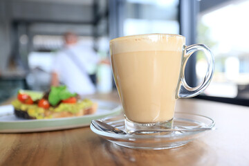 cappuccino, coffee in a clear glass cup in a cafe, soft color background food and drink, hot drink