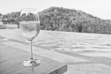 Wine glass close-up in real life, beautiful blurred background of the drink in the glass