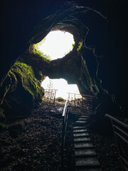 A captivating and mysterious cave, featuring enchanting glowing stairs, beckons curious souls to...