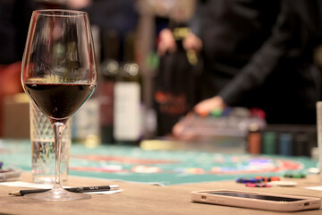 dinner in a restaurant with wine, beautiful table setting, a glass of wine in the foreground