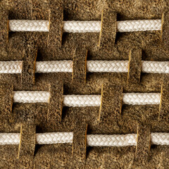 Seamless 4k photo texture material of brown suede leather pattern with rope inserts.