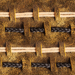 Seamless 4k photo texture material of brown suede leather with rope inserts and loops.