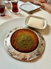 Middle eastern sweets kunefe kunafa kadayif with pistachio Turkish arabic traditional dessert