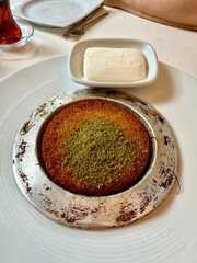 Middle eastern sweets kunefe kunafa kadayif with pistachio Turkish arabic traditional dessert