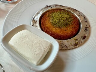 Middle eastern sweets kunefe kunafa kadayif with pistachio Turkish arabic traditional dessert