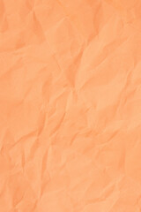 Crumpled orange paper with wrinkled and textured background