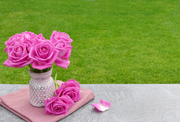 Bouquet of roses on a table in the garden.