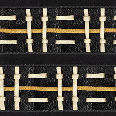 Seamless 4k photo texture material of black leather with braided rope inserts.