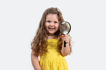 Little girl holding magnifier in her hand, investigation anddiscovery concept.