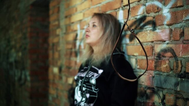 A desperate young girl prepares to commit suicide by hanging. Human hopelessness, suicide by hanging.