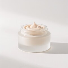 Luxury skincare cream in glass jar on soft white background