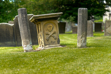 Eyam village Derbyshire UK. The site of the great bubonic plague. Ancient stone grave marker.