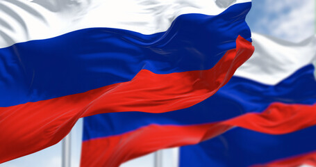 Several flags of the Russian Federation waving in the wind.