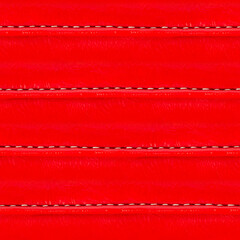 Seamless 4k photo texture material of red colored polished leather straps surface with seams.