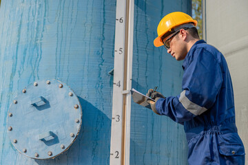 Engineers and technicians work at a water treatment and wastewater facility, monitoring systems,...