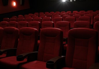 Fototapeta premium Empty movie theater with red seating and ambient lighting
